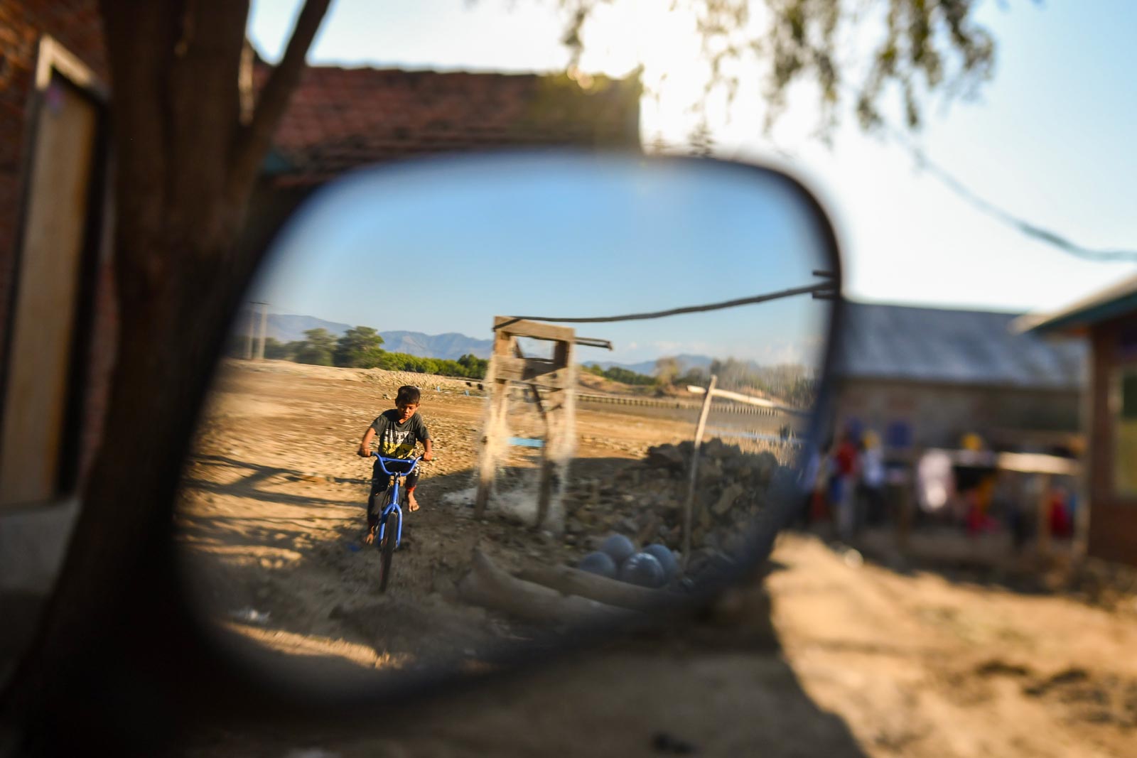 Out for a pedal at the edge of Kwangko. New bicycles are a common sight now as locals enjoy the income surge generated in part by the belated coming of electricity to the village. Photo: Simon Roughneen