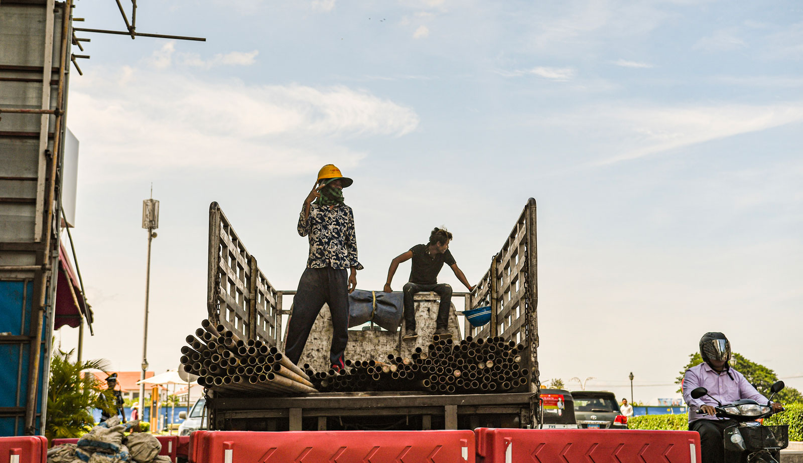 Construction workers unloading steel fixings near one of Phnom Penh's big casino buildings. Photo: Simon Roughneen