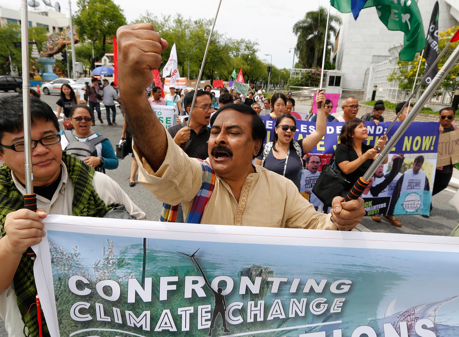 Climate activists shout slogans outside the United Nations office in Bangkok in September 2018. Photo: EPA-EFE/Narong Sangnak