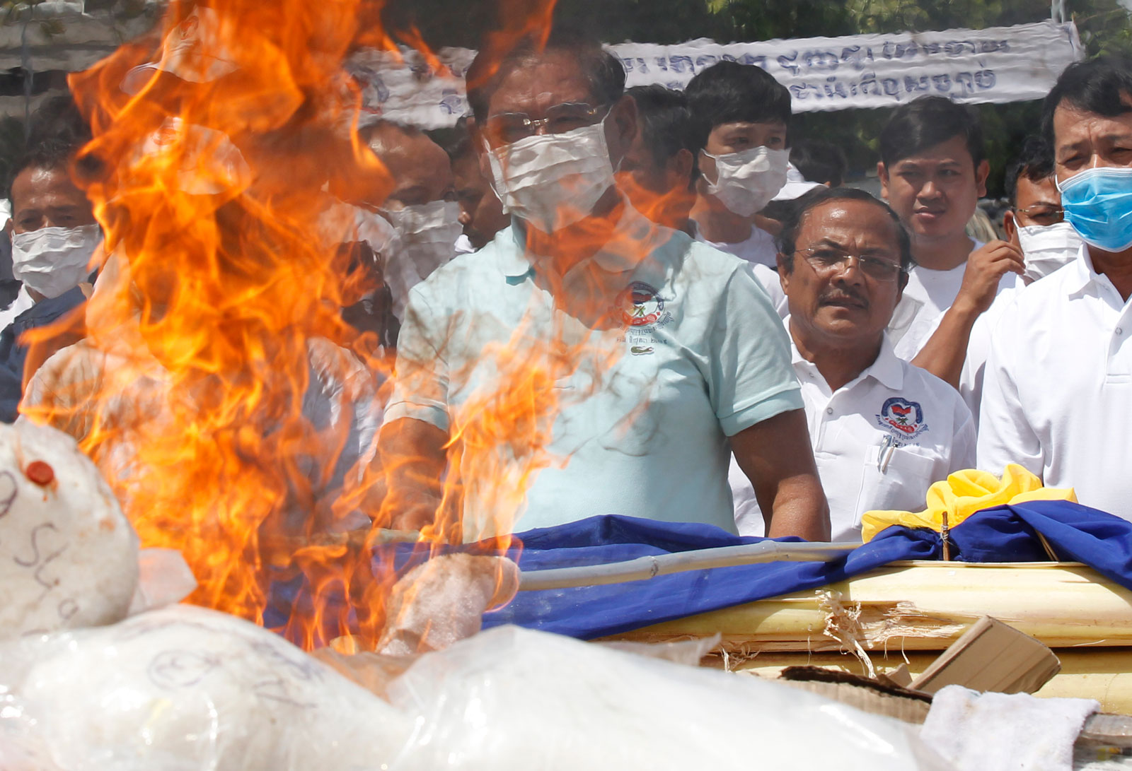 Cambodian Minister of Interior Sar Kheng (C), burns seized illegal drugs during a drug destruction event in Phnom Penh on 26 June 2019. The Cambodian National Authority for Combating Drugs destroyed two tons of illegal drug substance ingredients in an effort to fight against drug production, distribution and drug trafficking. Photo: EPA-EFE/Kith Serey