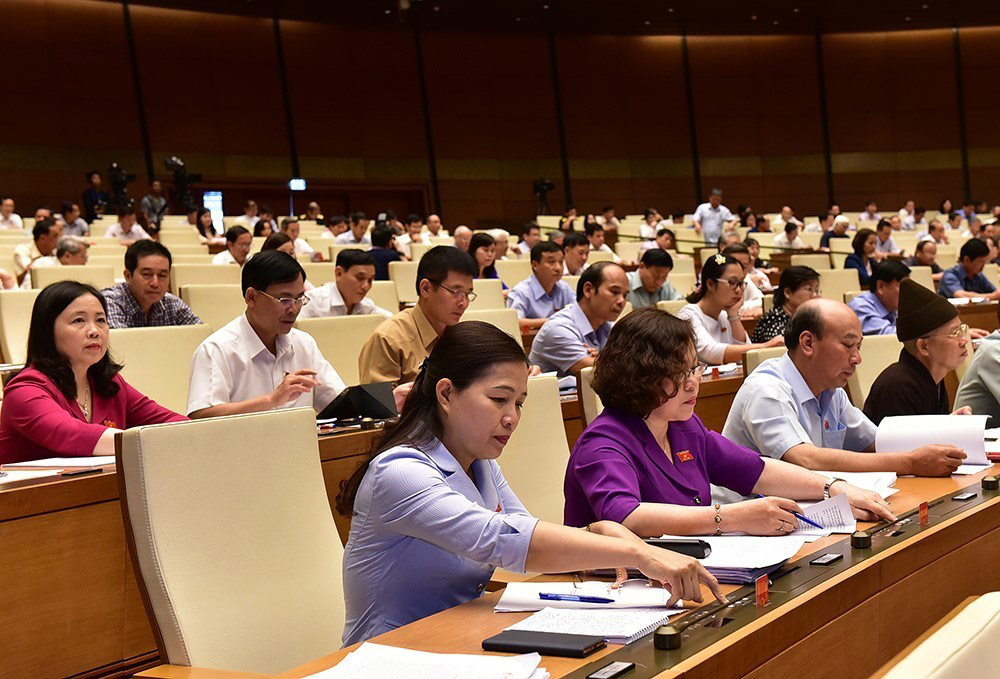 Members of Vietnam's parliament attend a session on a cybersecurity law in Hanoi in June 2018. 423 out of 466 of these present voted for the law, which requires service providers such as Google and Facebook to store user data in Vietnam and remove critical posts within 24 hours. Photo: EPA-EFE/Vietnam News Agency