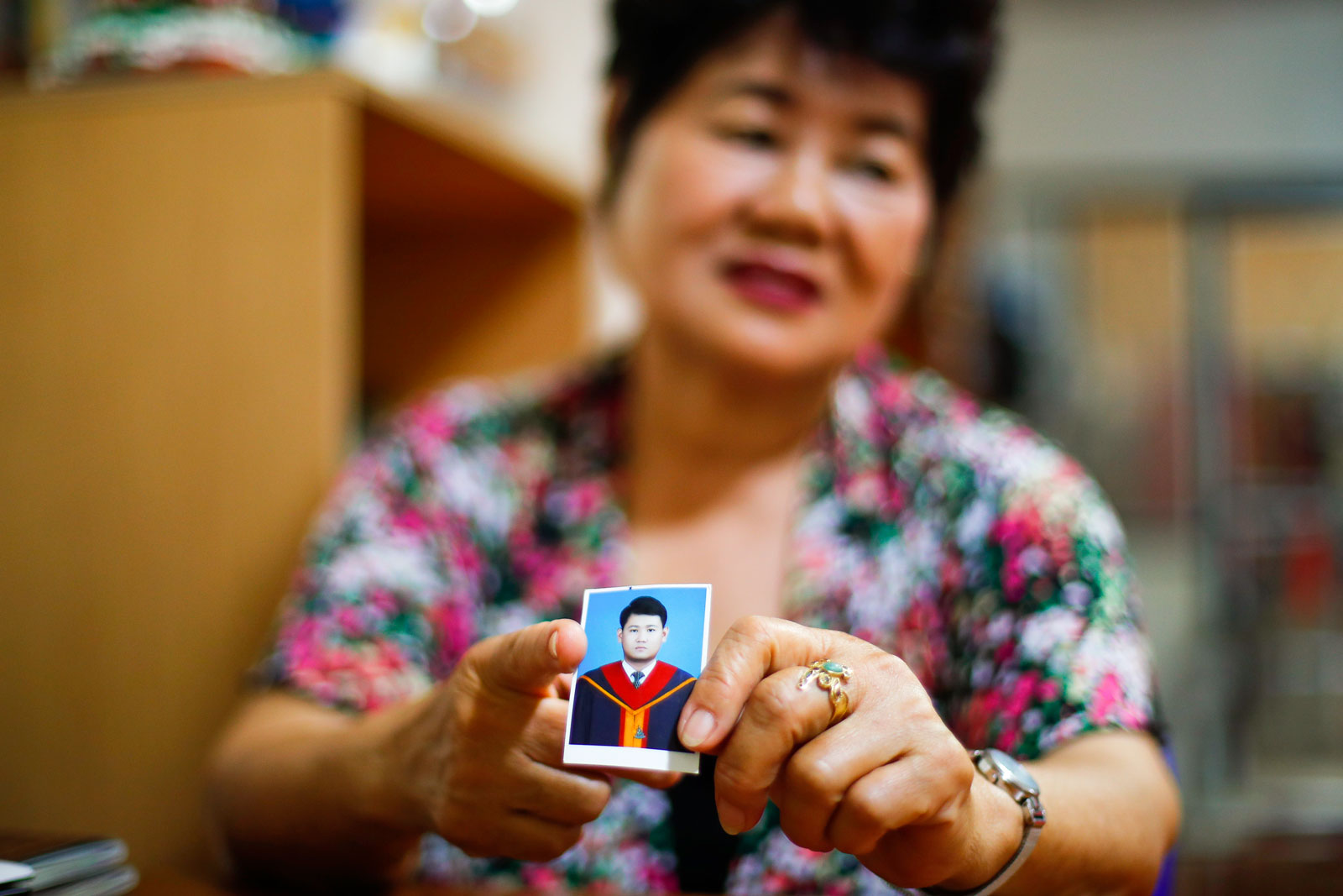 Kanya Theerawut, mother of Thai dissident Siam Theerawut, holds a photo of her son during an interview at her home in Bangkok on 21 May 2019. Photo: EPA-EFE/Diego Azubel