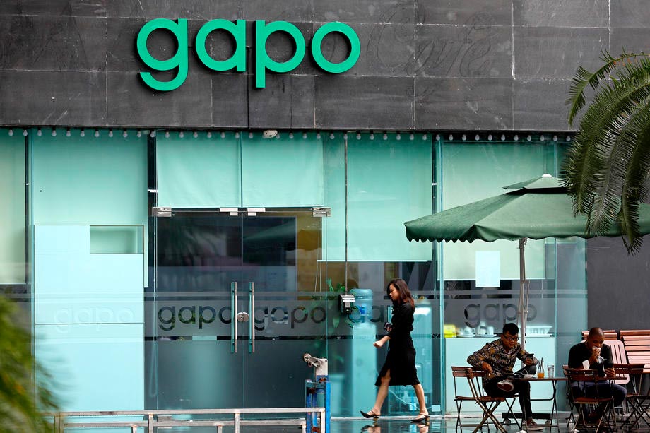 A woman walks past the office of new Vietnamese social media application Gapo, in Hanoi on 1 August 2019. The app was launched on 23 July. Photo: EPA-EFE/Minh Hoang