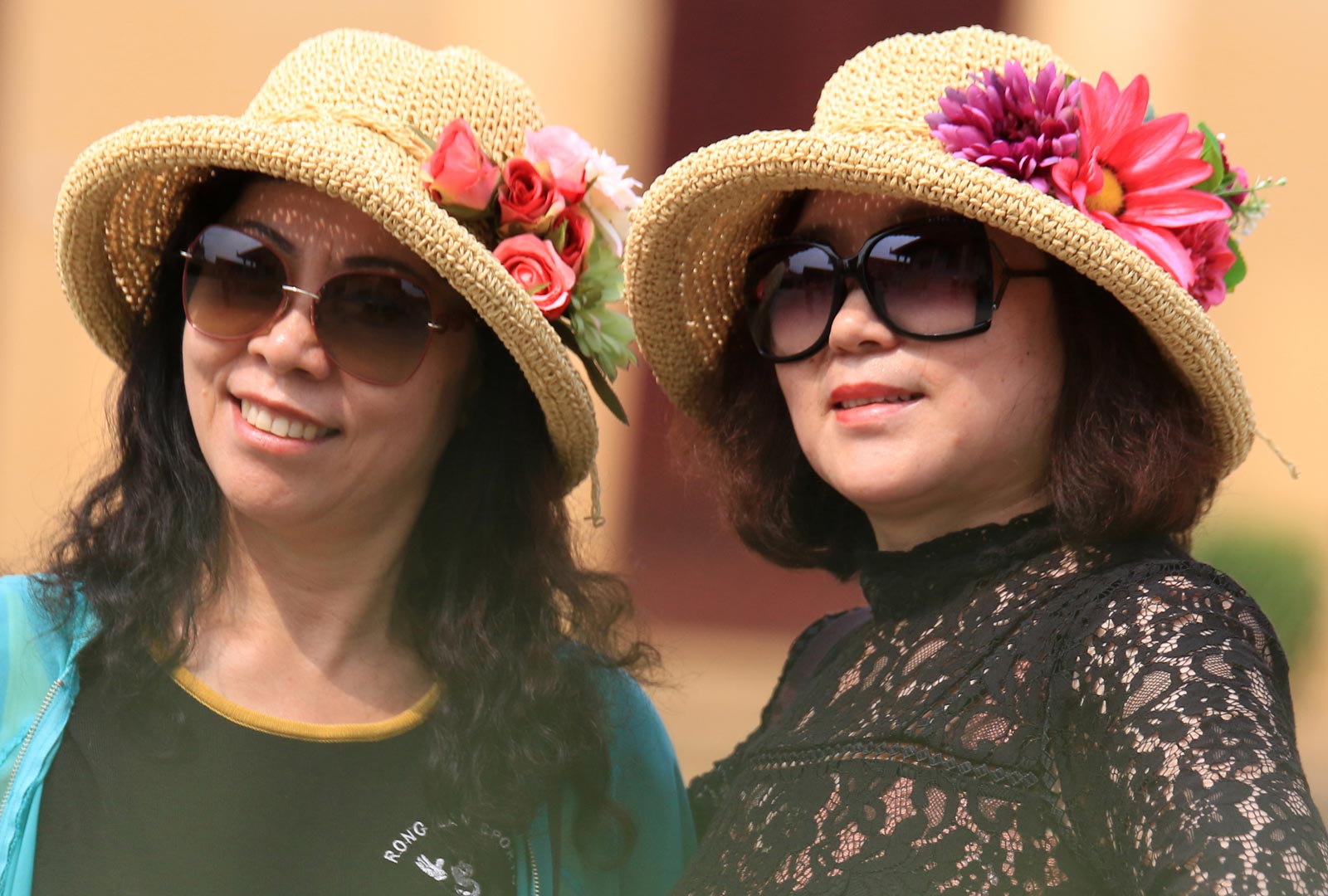 Chinese tourists pose for the pictures as they visit the Royal Palace in Phnom Penh. Photo: EPA/Kith Serey