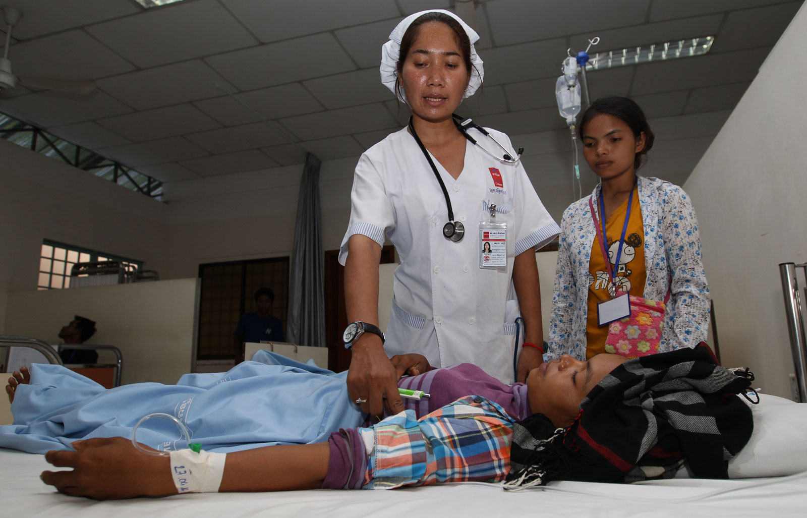 Nurse checks on a garment worker injured in a car crash, at Calmette Hospital in Phnom Penh, April 2016. Photo: EPA/Mak Remissa