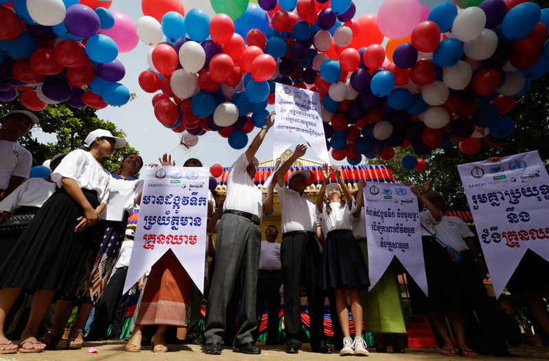 Cambodian Minister of Health Mam Bun Heng) releases balloons during the National Dengue Fever Campaign Day in July 2017, when health officials trained school children about dengue fever prevention. Photo: EPA/Mak Remissa